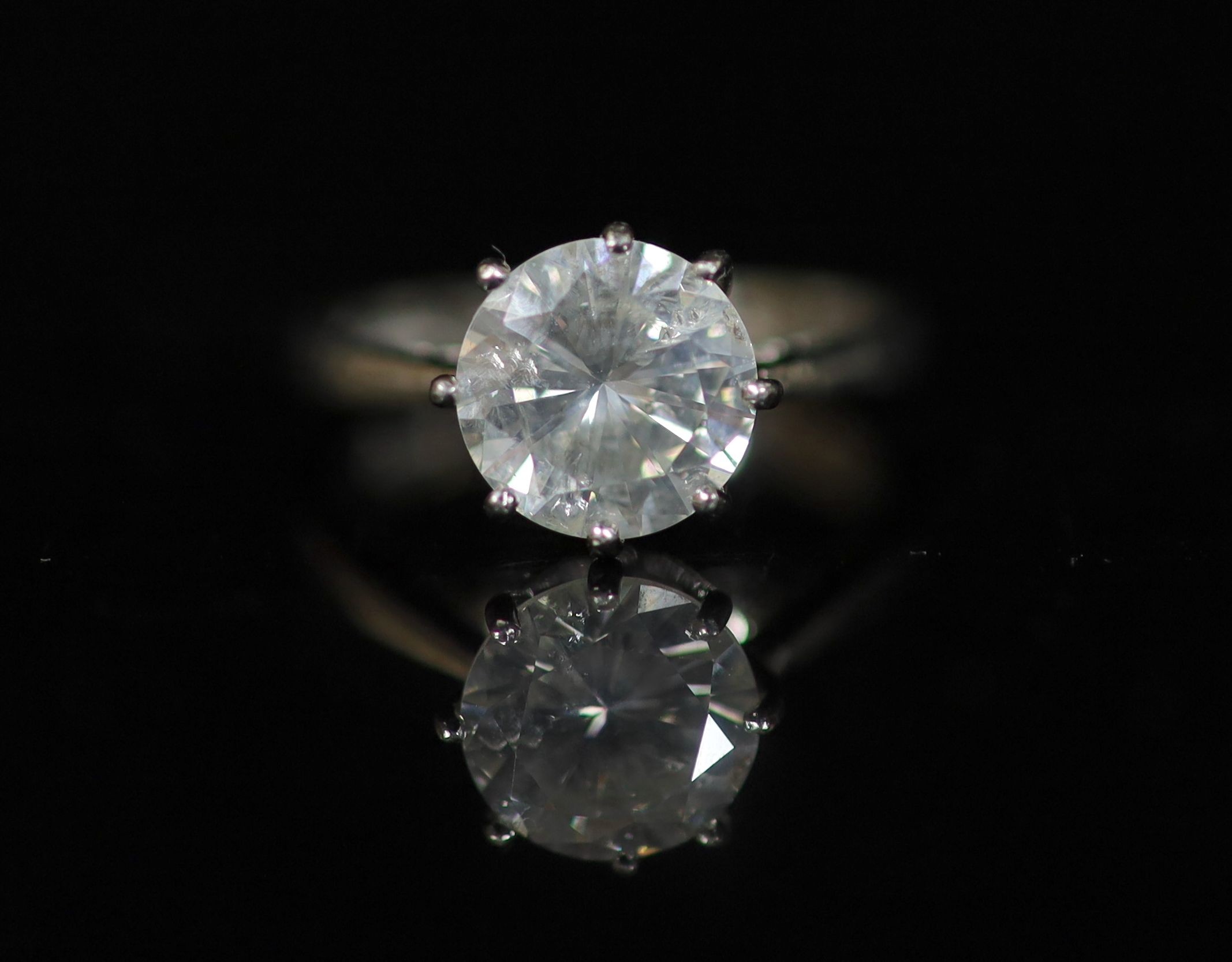 A modern platinum and solitaire diamond ring